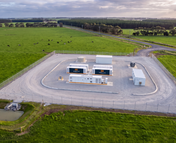 Aerial view of a battery compound on green pasture, with cattle grazing nearby